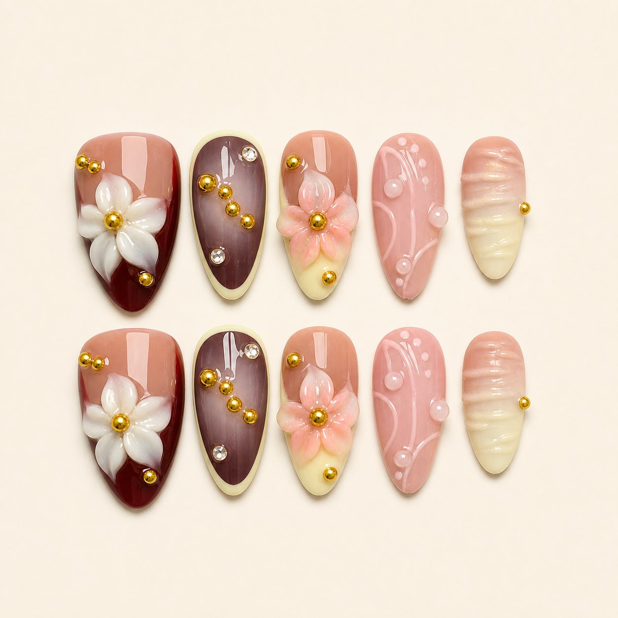 Pink burgundy camellia press-on nails set on warm ivory background