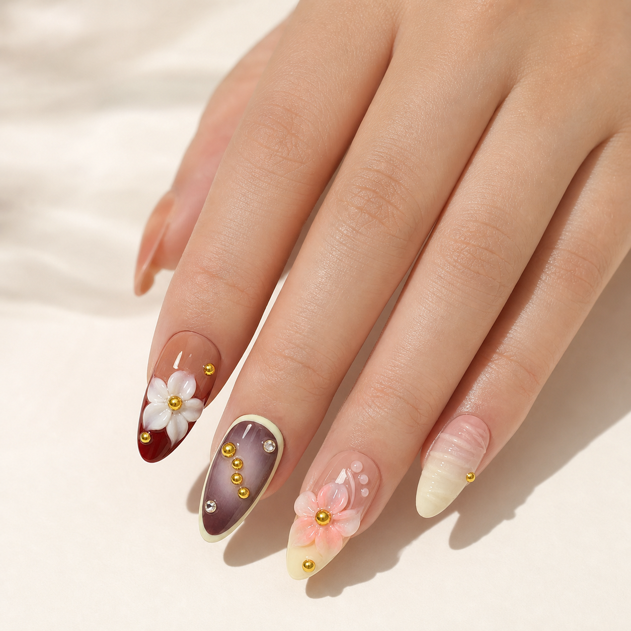 Model wearing pink burgundy camellia press-on nails