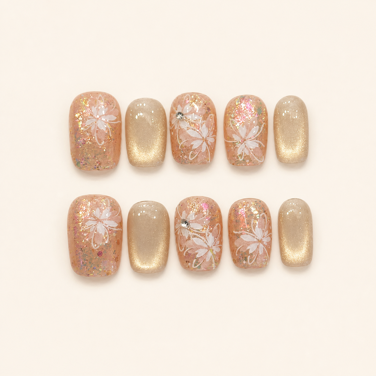 Champagne nude floral press-on nails set on warm ivory background