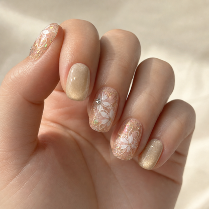 Model wearing champagne nude floral press-on nails